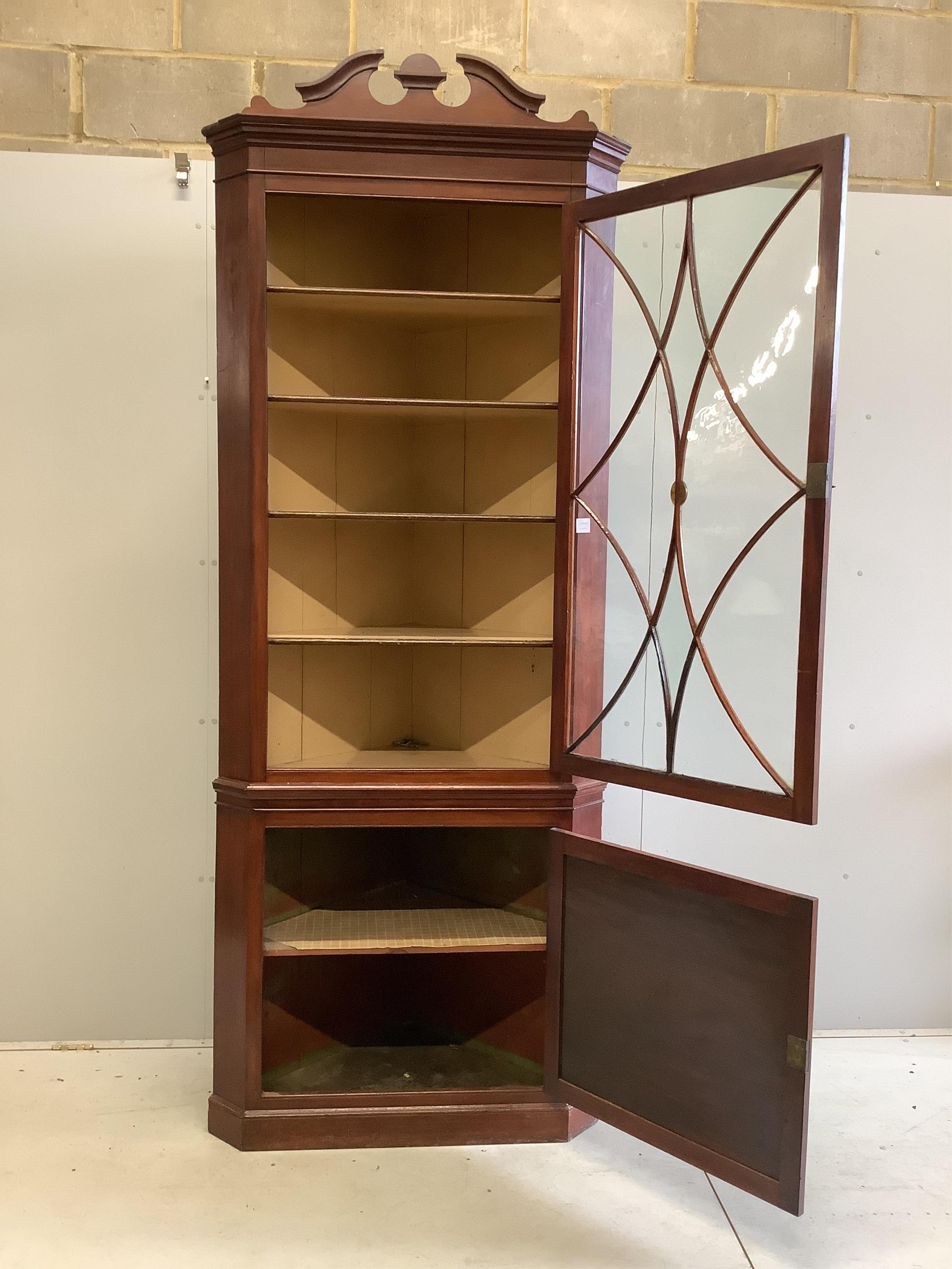 A large 19th century mahogany standing corner cupboard, on plinth base, width 94cm, depth 56cm, height 240cm. Condition - fair